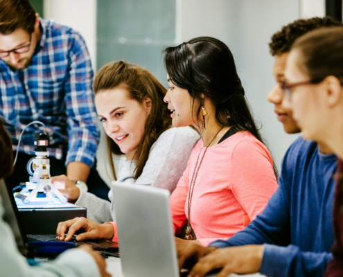 A group of young university students on an experiments together in the lab.