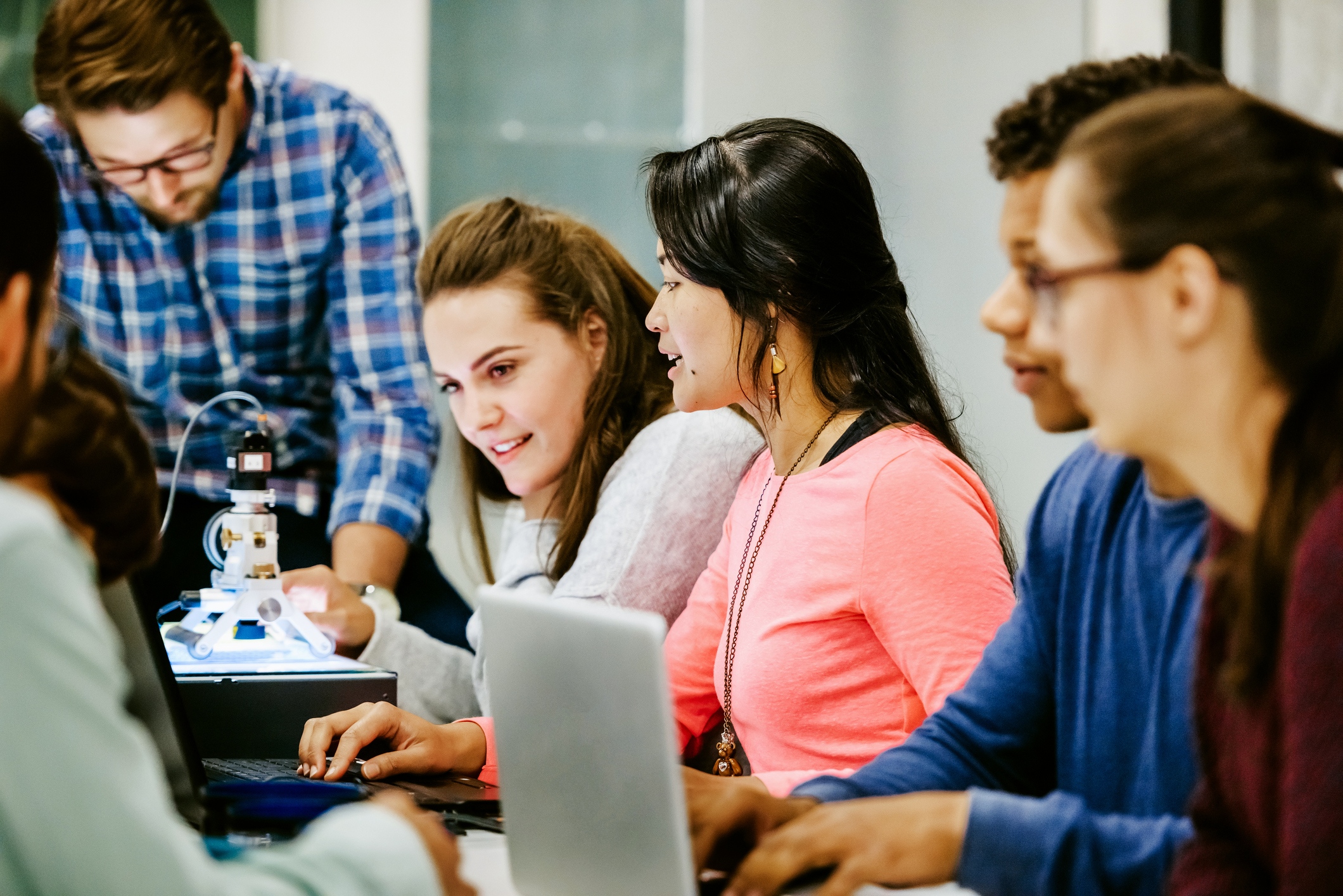 A group of young university students on an experiments together in the lab.
