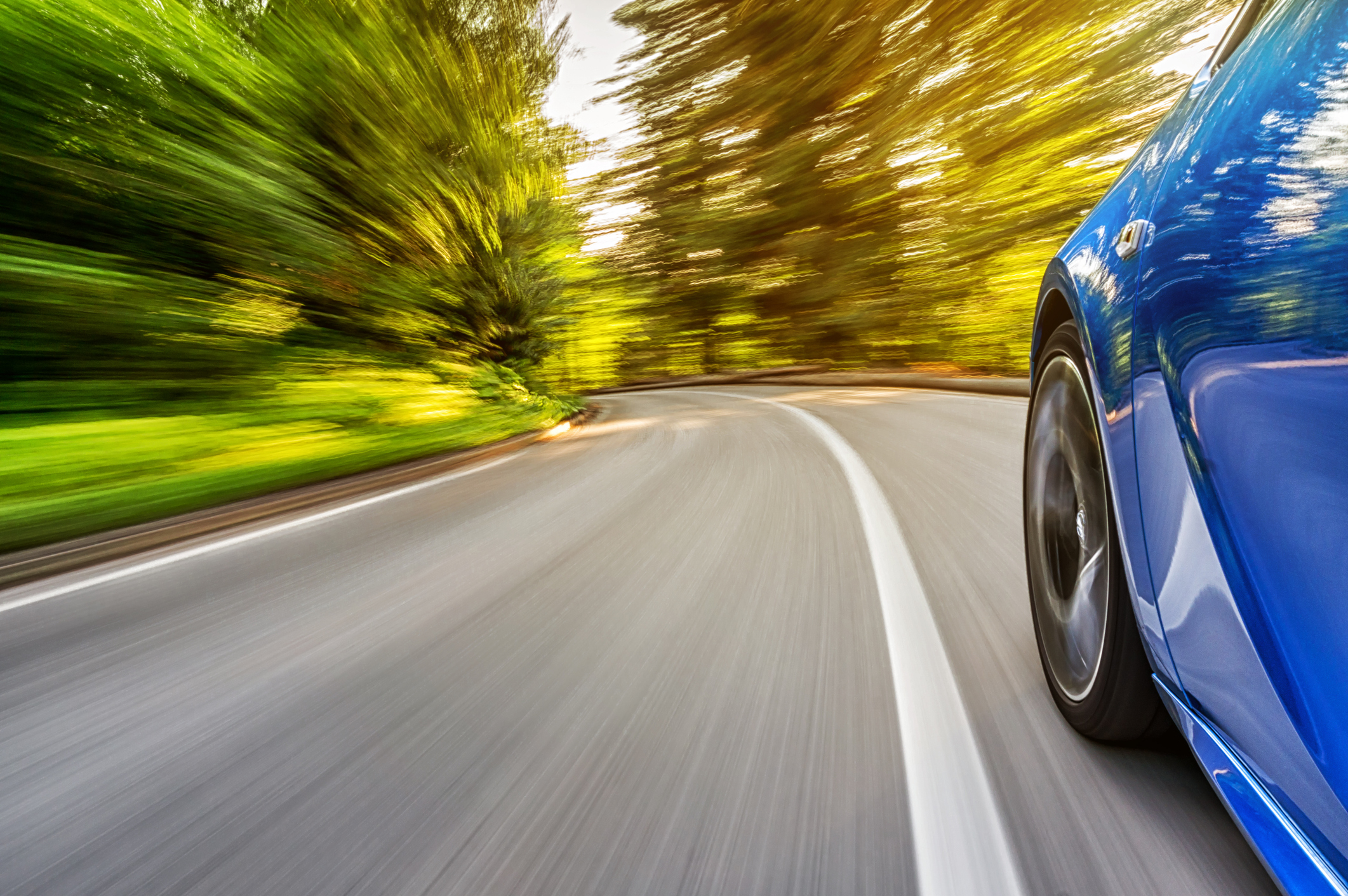 Motion blur shot of a sports car driving fast on a mountain road