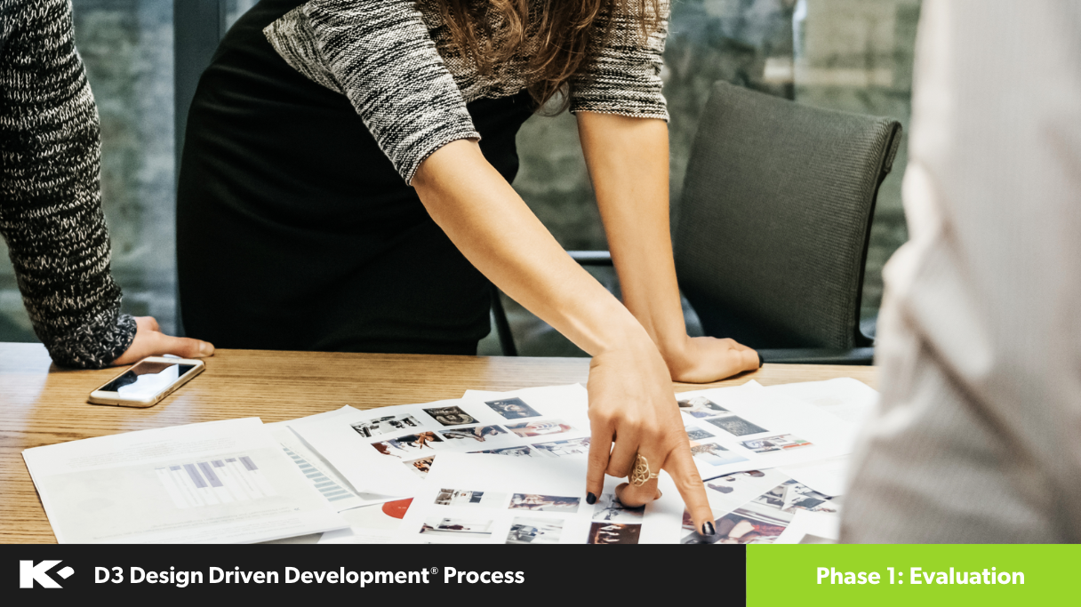 A woman leans over a table, pointing at printed documents and photos during a meeting. Two other people stand nearby, and a smartphone rests on the table. Text reads: "D3 Design Driven Development Process, Phase 1: Evaluation.